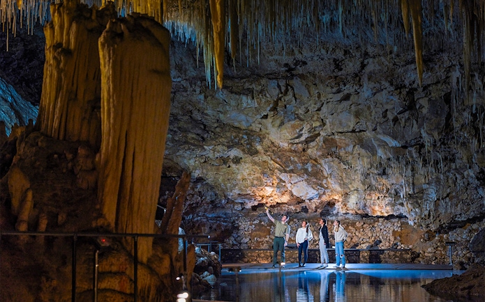 Guide explains cave formations to visitors in Lake Cave, Margaret River.