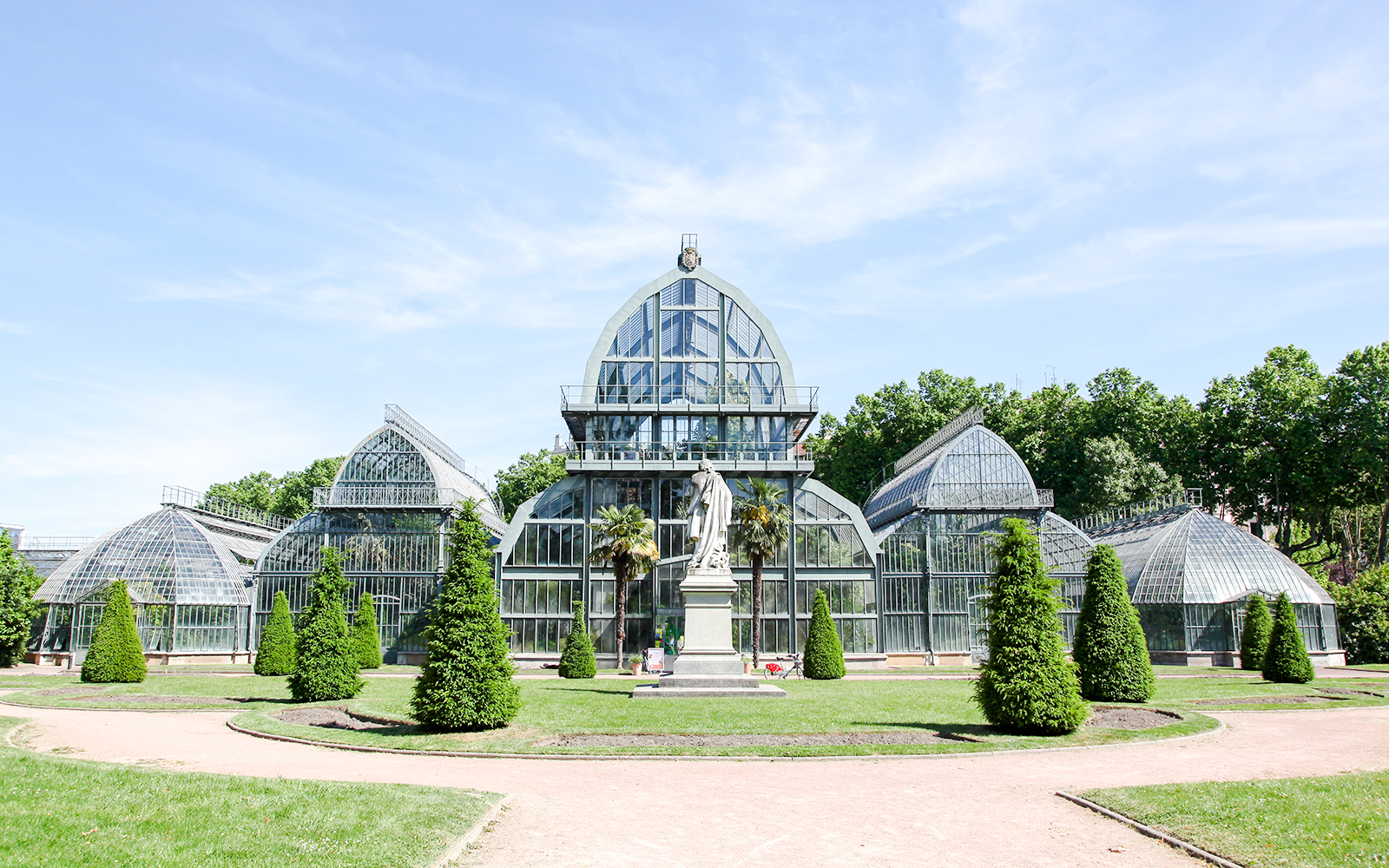 Greenhouse in Parc de la Tête d'Or, Lyon, France with surrounding greenery.