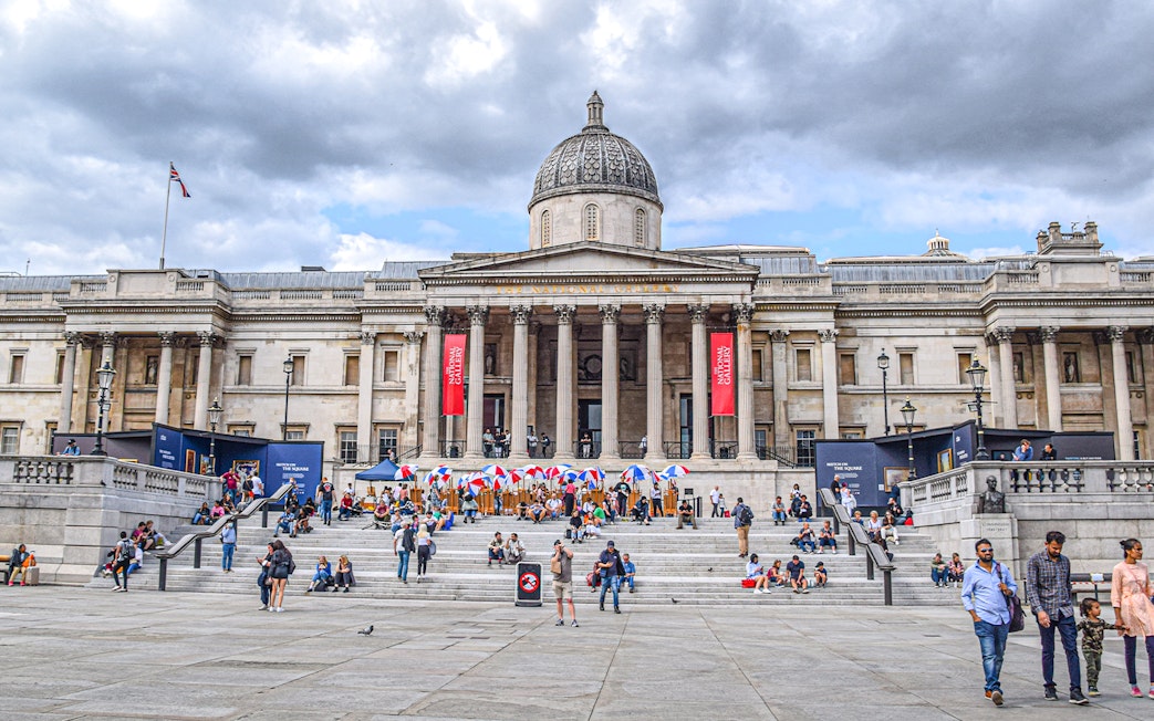 Trafalgar Square with visitors in front of the National Gallery, London.