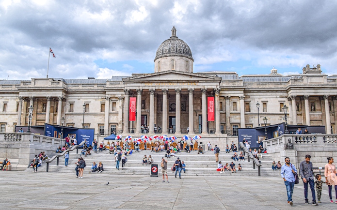 Trafalgar Square with visitors in front of the National Gallery, London.