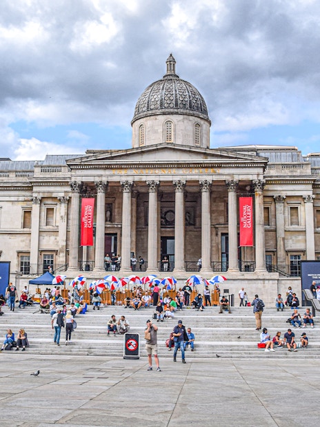 Trafalgar Square with visitors in front of the National Gallery, London.