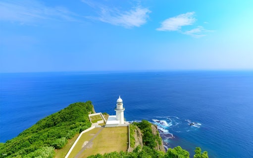 Lighthouse on a cliff overlooking the ocean in Hokkaido, Japan.
