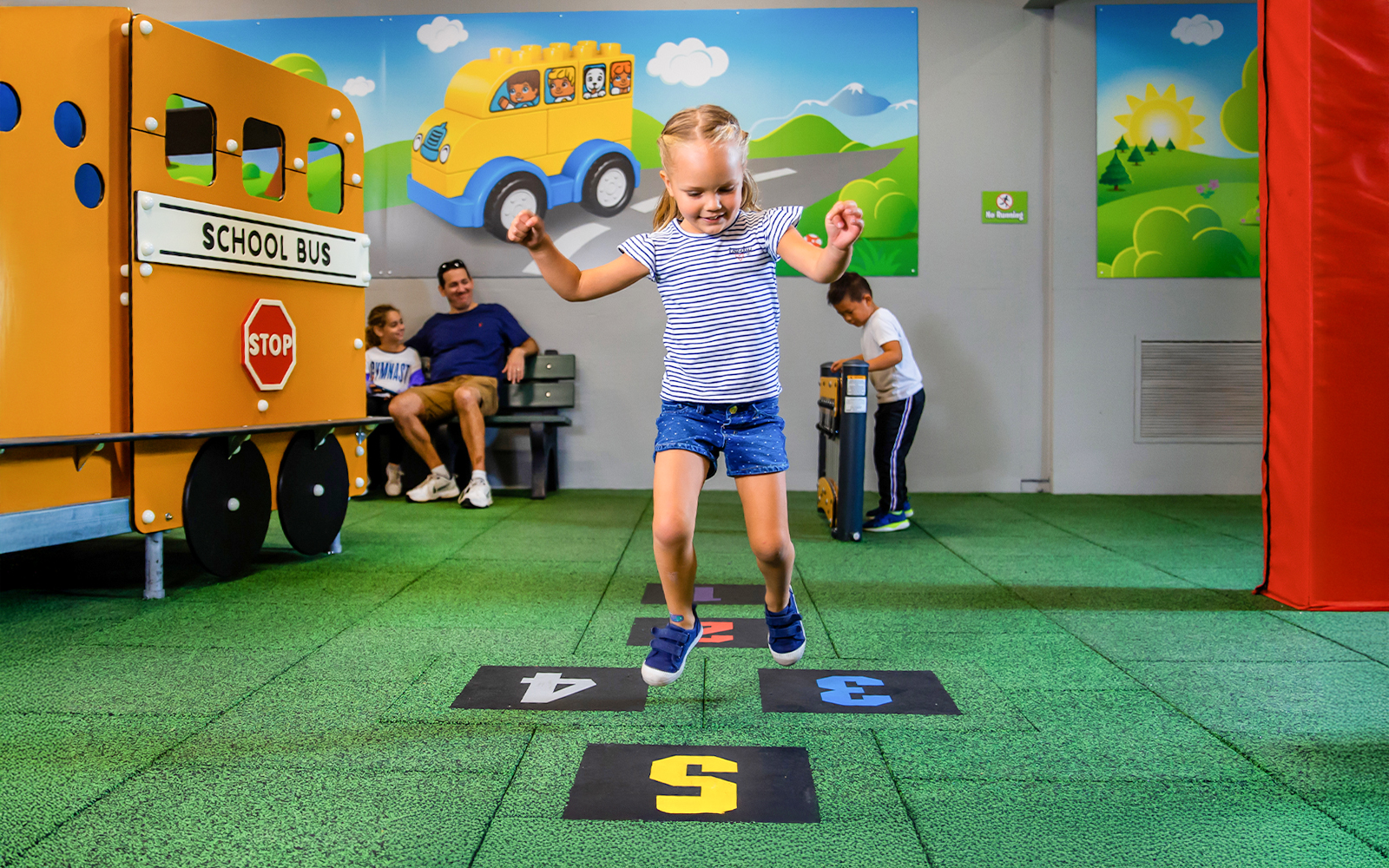 Child playing hopscotch at Duplo SchoolHouse, LEGOLAND Florida.