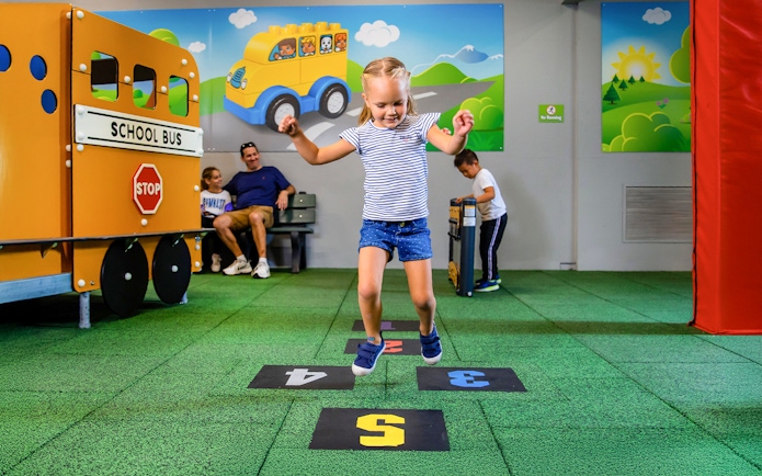 Child playing hopscotch at Duplo SchoolHouse, LEGOLAND Florida.