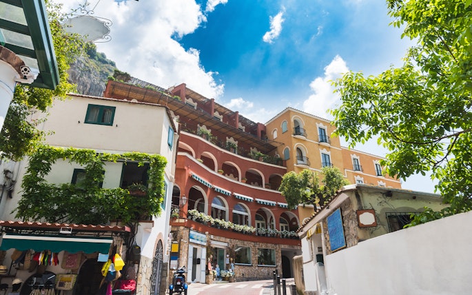 Colorful buildings along a road in Positano city center, Italy.