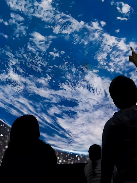 Visitors observing Earth projection at Planetarium, ARTIS Amsterdam Royal Zoo.