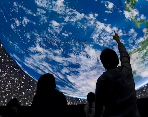 Visitors observing Earth projection at Planetarium, ARTIS Amsterdam Royal Zoo.