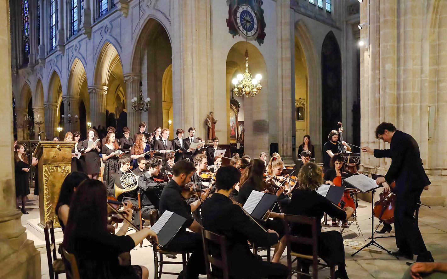 Orchestra performing inside Church of St Madeleine, Paris, France.