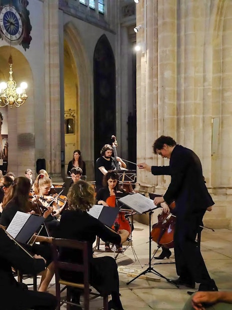Orchestra performing inside Church of St Madeleine, Paris, France.