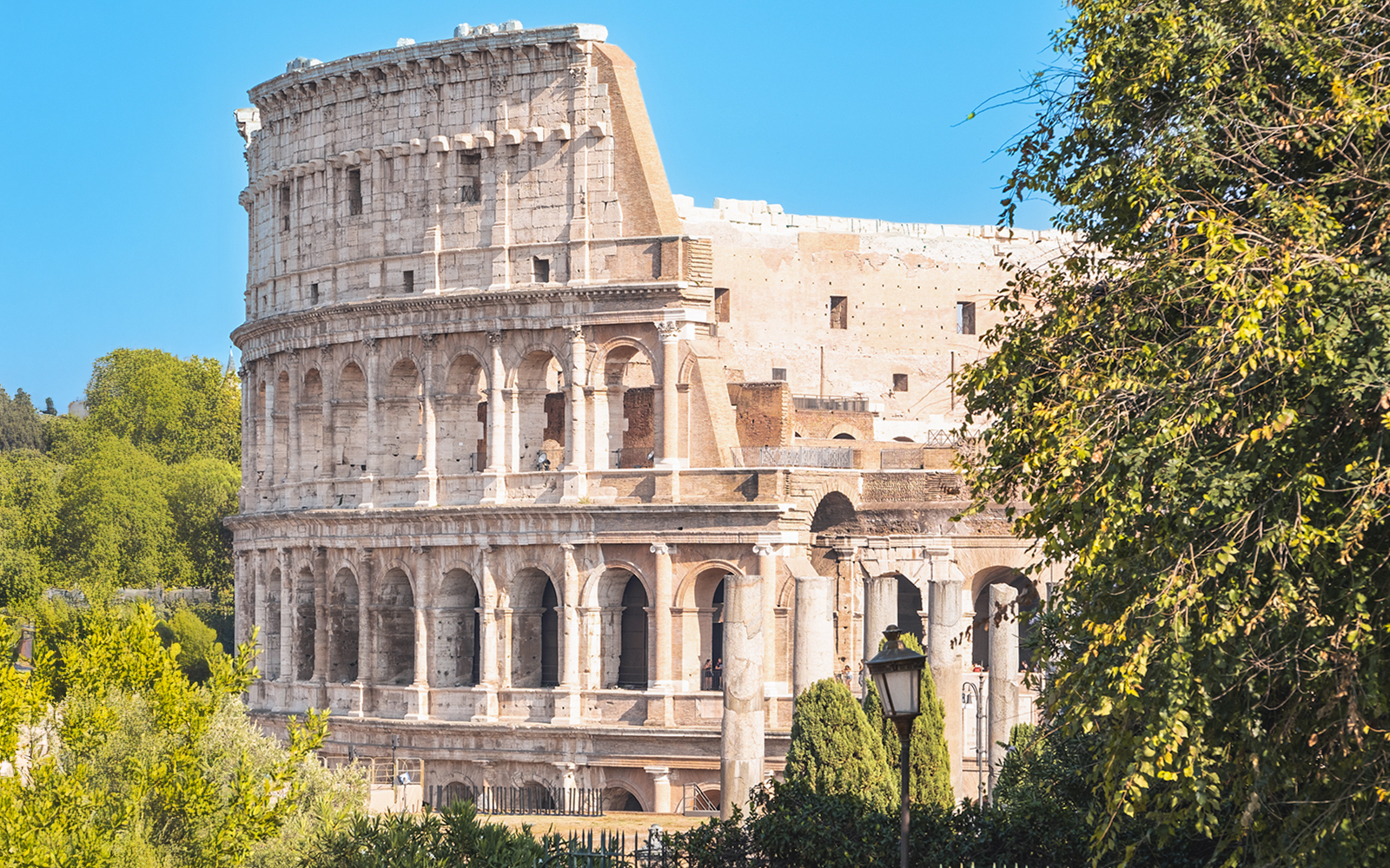 Golf cart near Colosseum during Rome: Eternal City Highlights Tour.