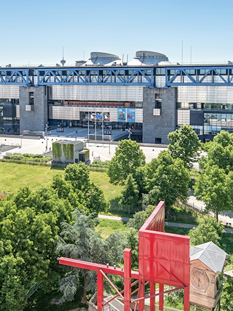 Science and Industry Museum in Paris with surrounding greenery and modern architecture.