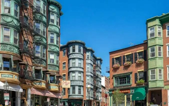 Historic buildings in Boston's North End on a sunny day, part of a self-guided city exploration game.