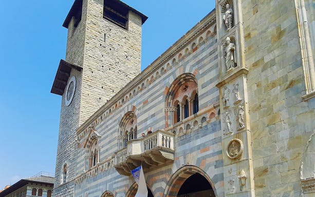 Como Cathedral facade with clock tower, part of 2-hour audio guide tour in Como City.