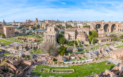 Roman Forum and Palatine Hill ruins in Rome, Italy, with ancient temples and arches.