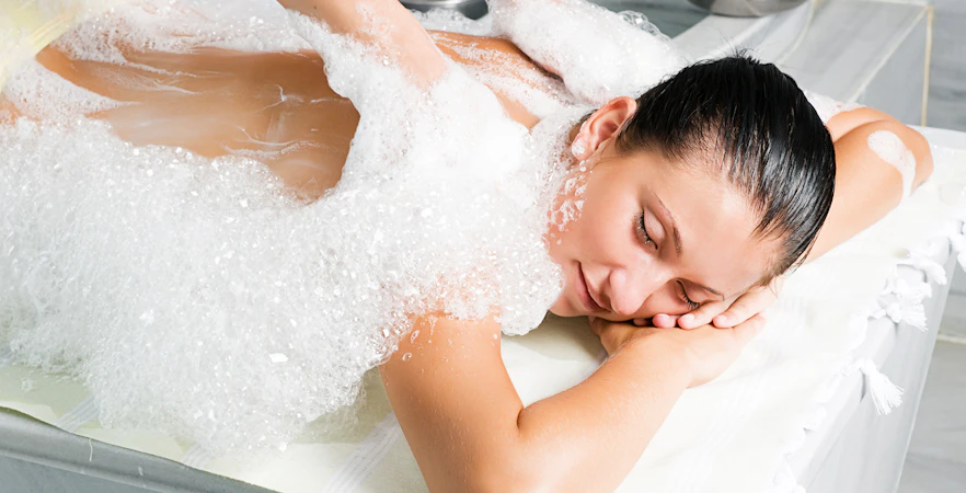 Person receiving a foam massage in a traditional Turkish bath in Antalya.