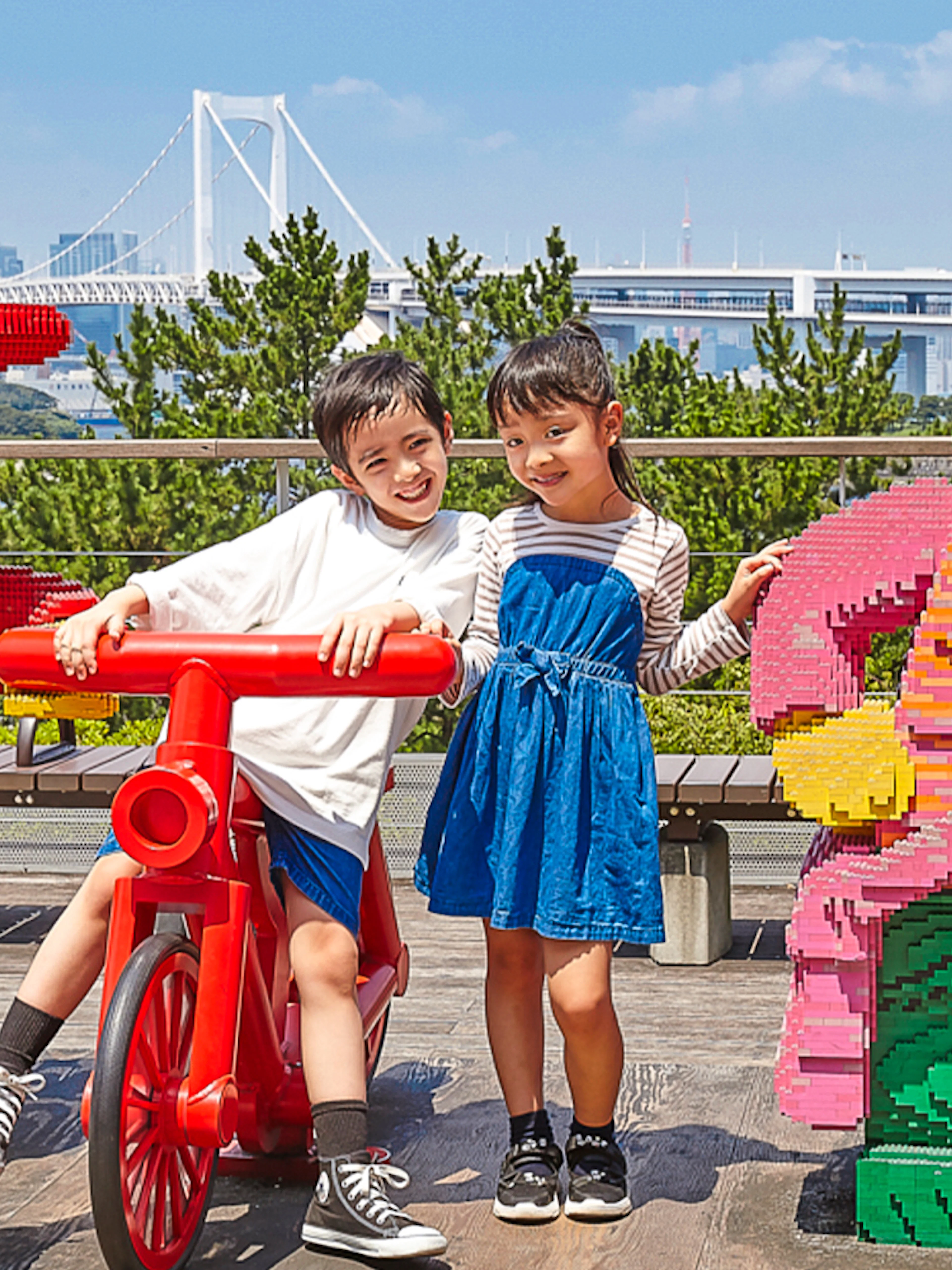 Children posing with LEGO figures at LEGOLAND Discovery Center Tokyo.