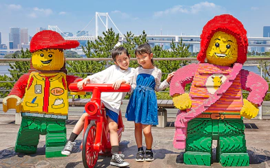 Children posing with LEGO figures at LEGOLAND Discovery Center Tokyo.