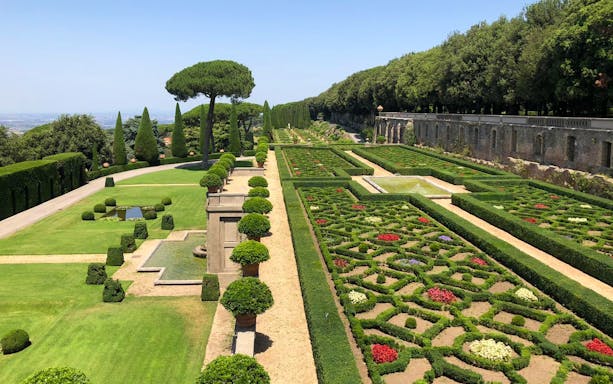 Castle Gandolfo garden with manicured hedges, fountains, and scenic pathways.