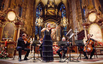 Performers playing string instruments inside St. Stephen's Cathedral, Vienna.