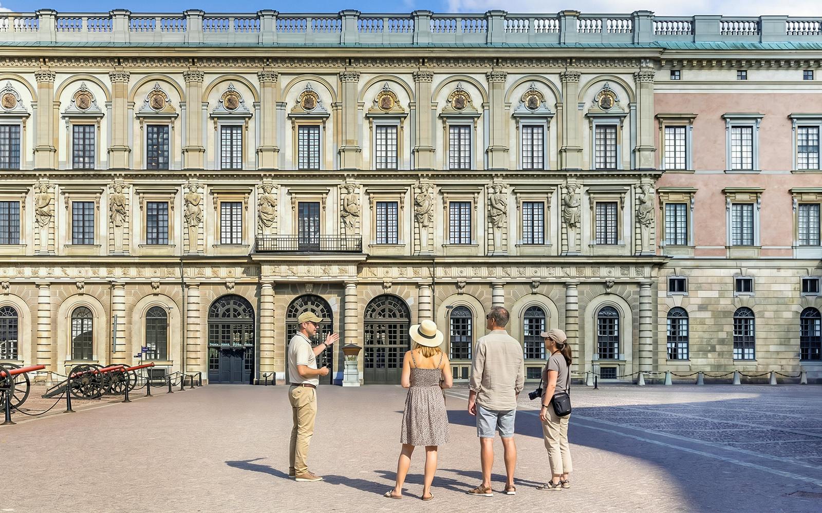 Tour group in front of historic royal palace facade in Stockholm, Sweden.