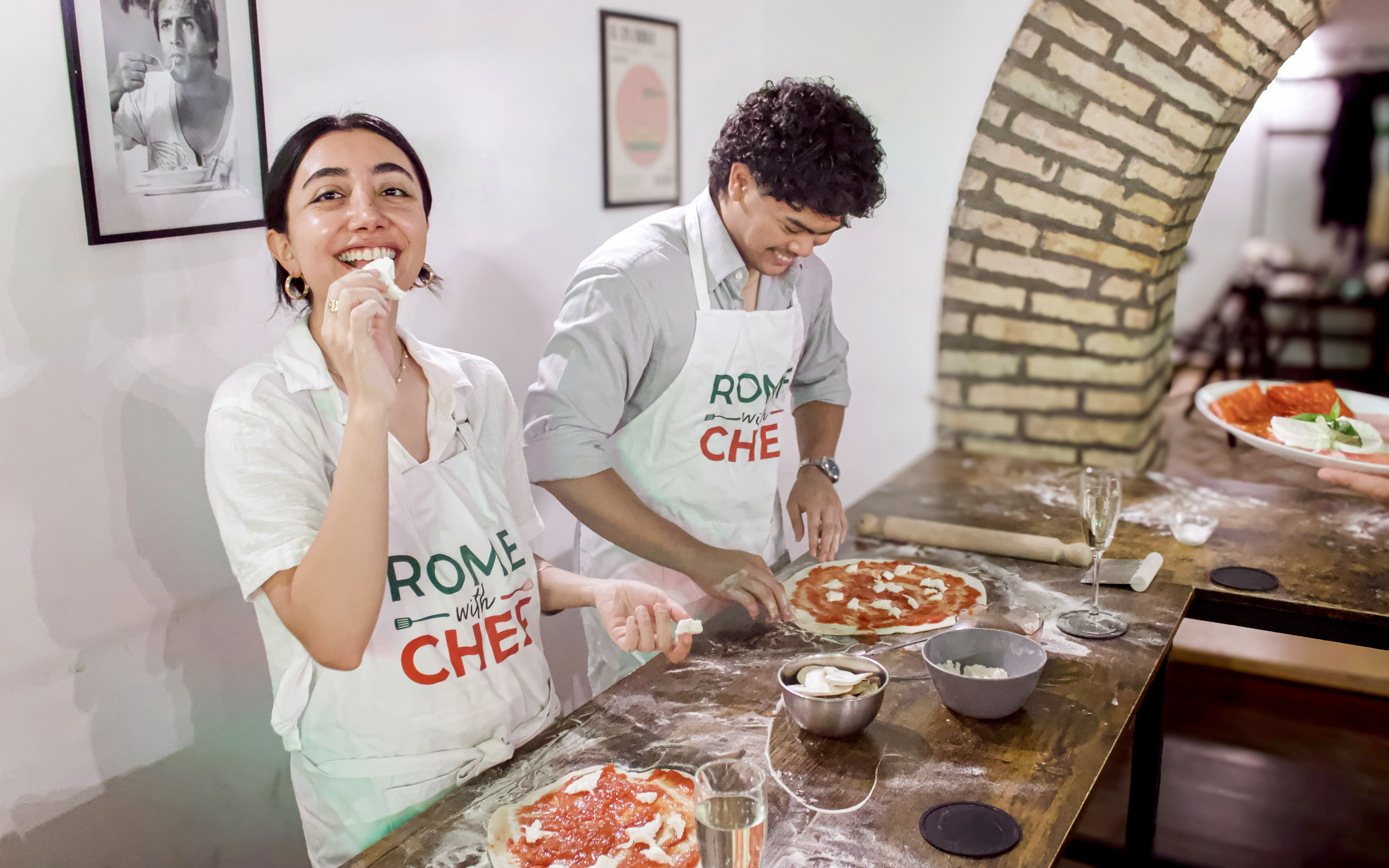 Participants making pizza in a Rome cooking class.