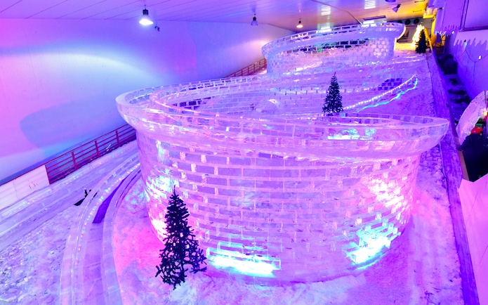 Glacier luge track with ice walls and snow at Singapore Snow City.