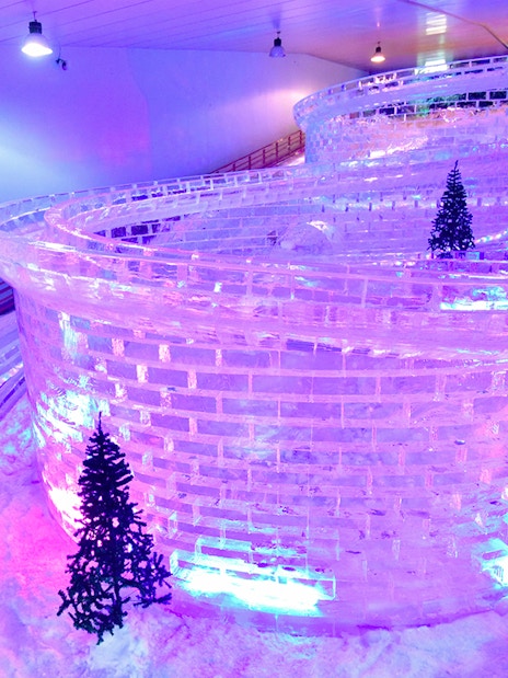 Glacier luge track with ice walls and snow at Singapore Snow City.