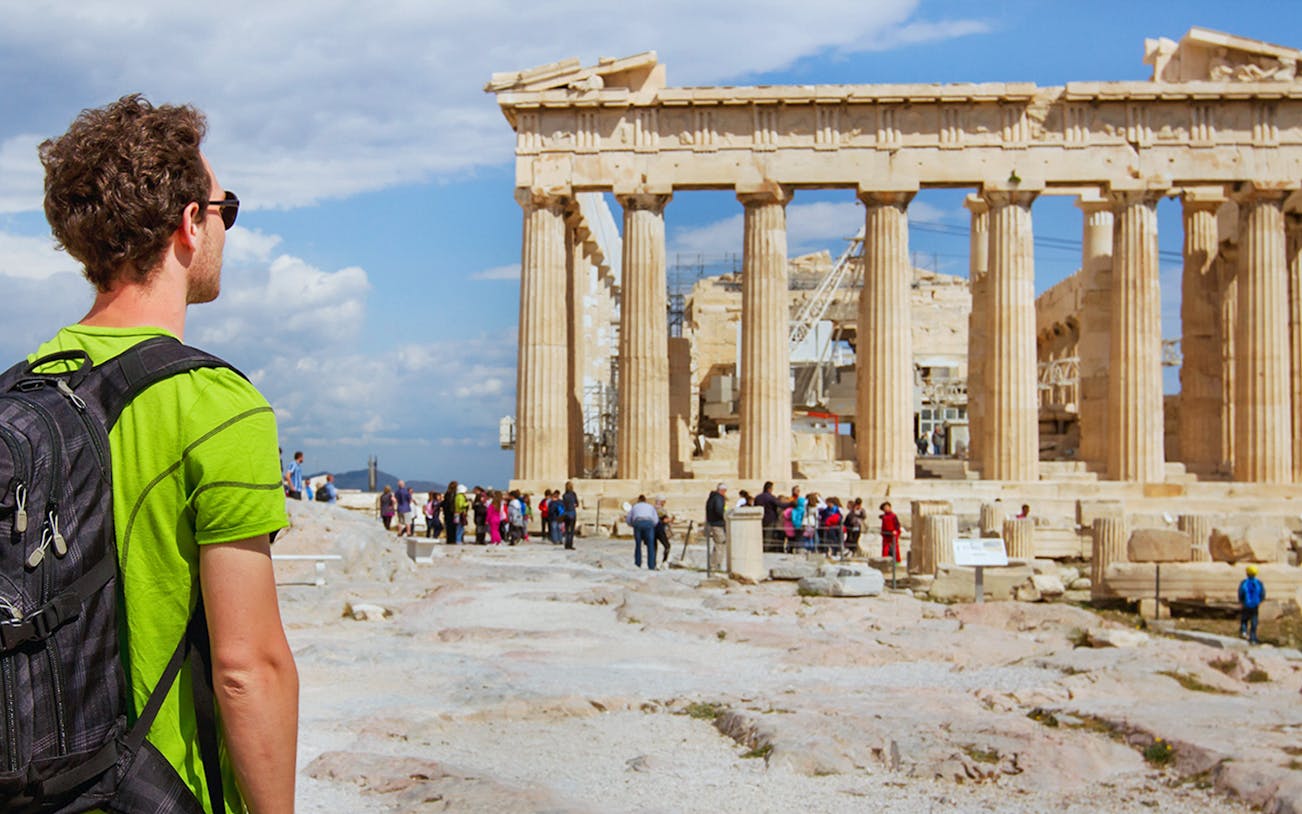 Tourist viewing the Parthenon on the Acropolis in Athens, Greece.
