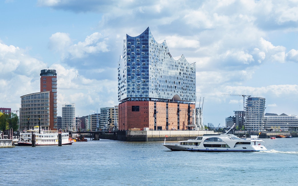 Elbphilharmonie concert hall in Hamburg with boats on the Elbe River.