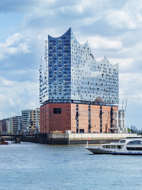 Elbphilharmonie concert hall in Hamburg with boats on the Elbe River.
