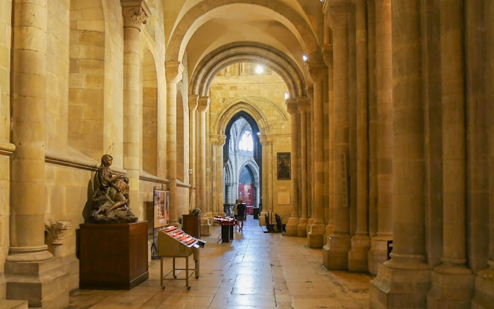Interior of Se de Lisboa cathedral showcasing arches and stone columns.