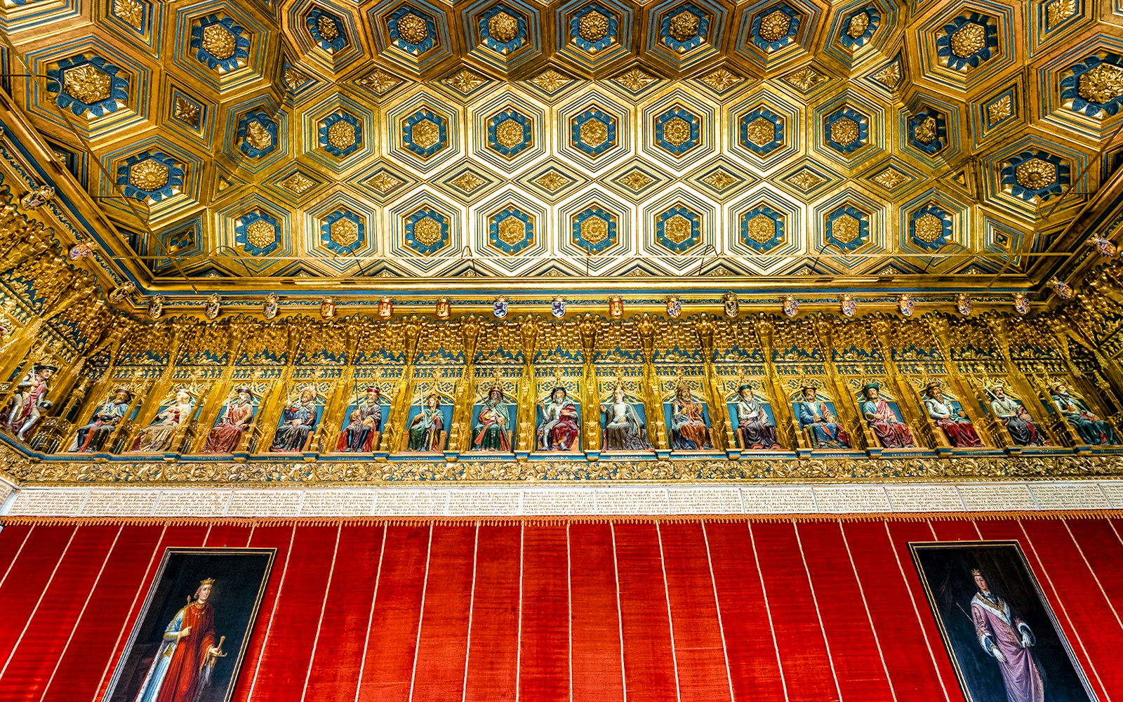 Alcazar Palace Hall of Kings ceiling with intricate gold and blue geometric patterns.