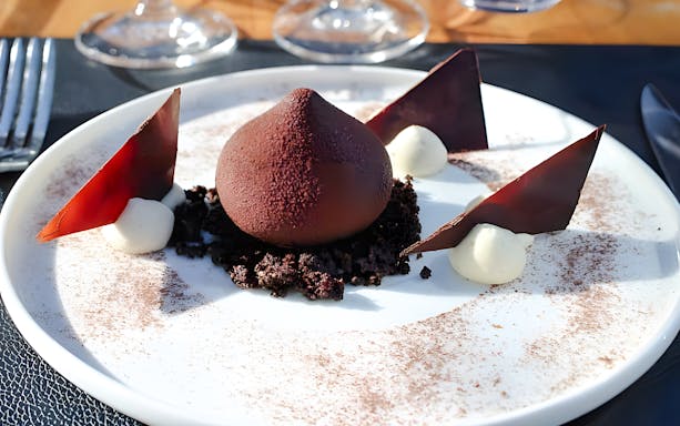 Chocolate dessert with mousse and shards on Bustronome Paris tour.