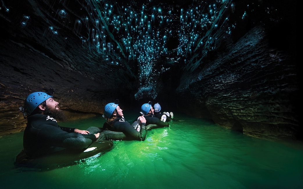 Guided black water rafting under glowworms in Waitomo Cave, New Zealand.