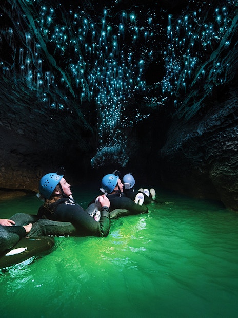 Guided black water rafting under glowworms in Waitomo Cave, New Zealand.