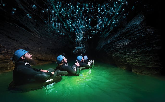 Guided black water rafting under glowworms in Waitomo Cave, New Zealand.