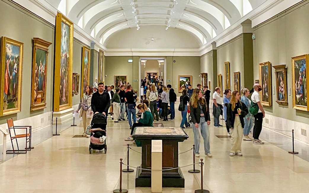 Visitors viewing Goya paintings at the Prado Museum exhibition in Madrid.