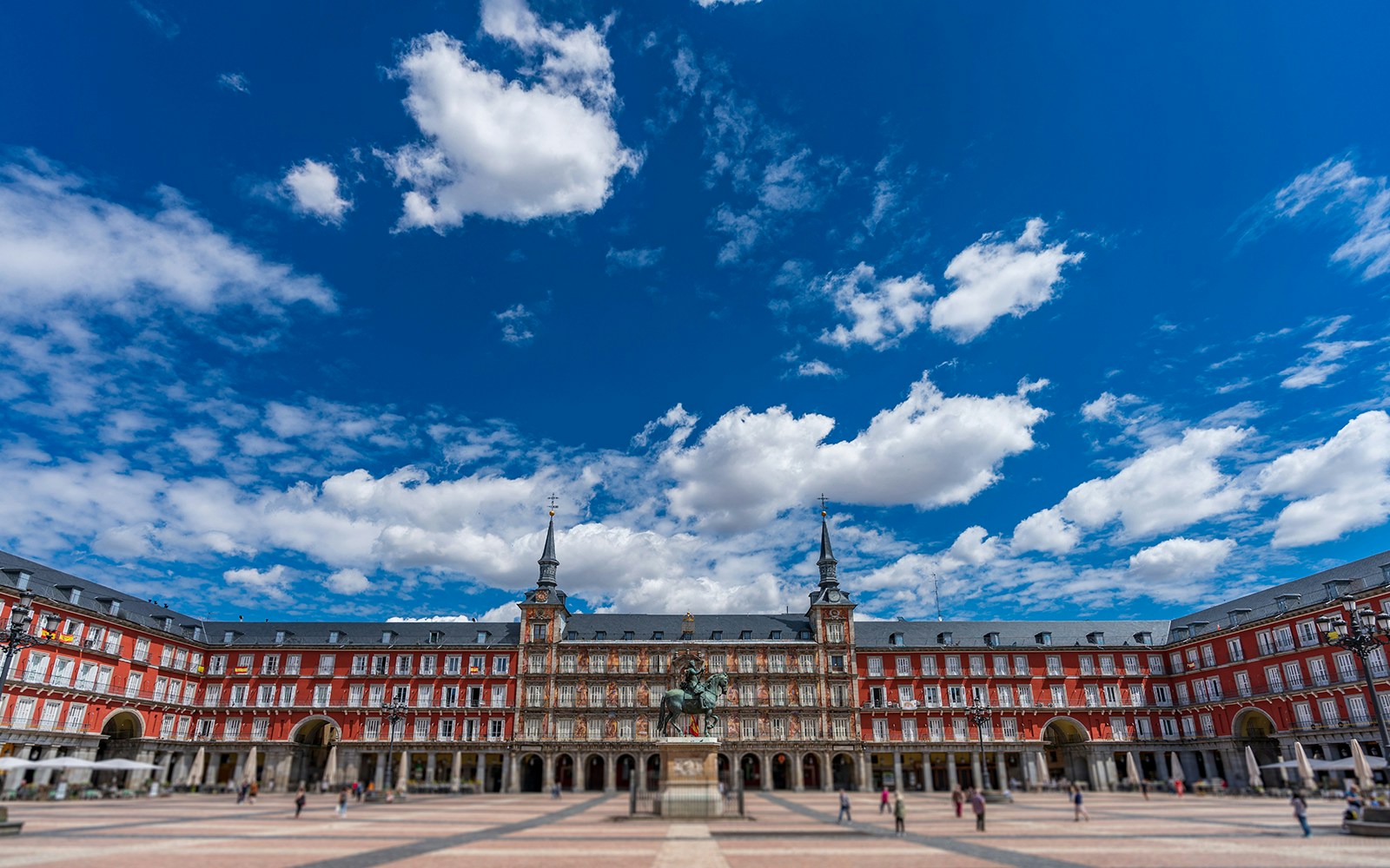 Plaza Mayor in Madrid with equestrian statue and historic buildings.