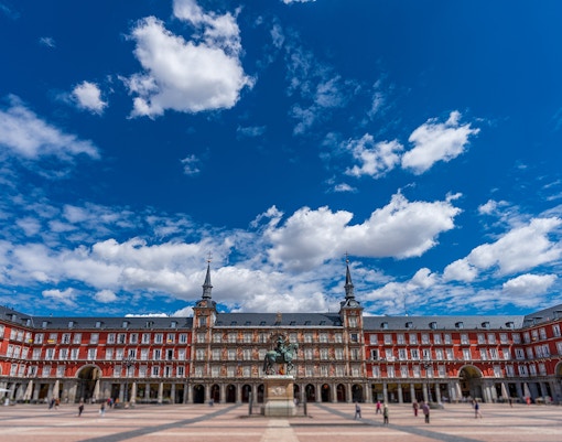 Plaza Mayor in Madrid with equestrian statue and historic buildings.