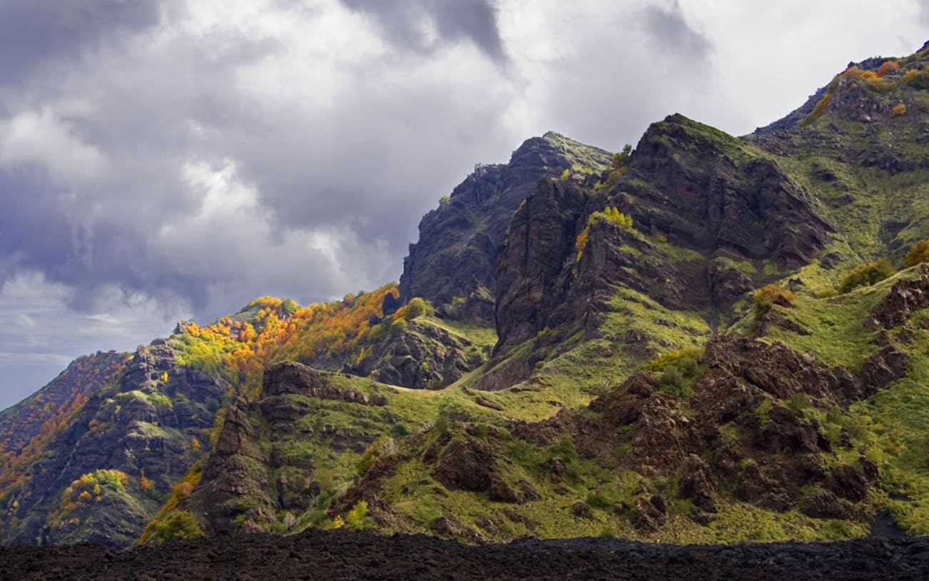 Mount Etna guided tour with cable car, showcasing volcanic landscape and trekking path.