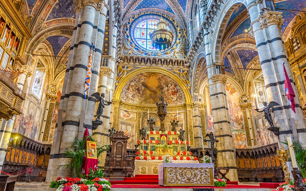Siena Cathedral Presbytery altar with ornate decorations and frescoes.