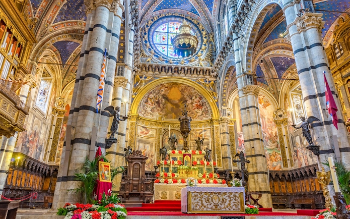Siena Cathedral Presbytery altar with ornate decorations and frescoes.