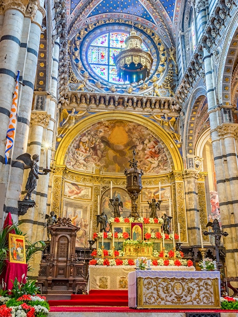 Siena Cathedral Presbytery altar with ornate decorations and frescoes.