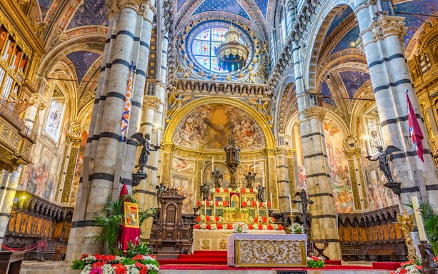 Siena Cathedral Presbytery altar with ornate decorations and frescoes.