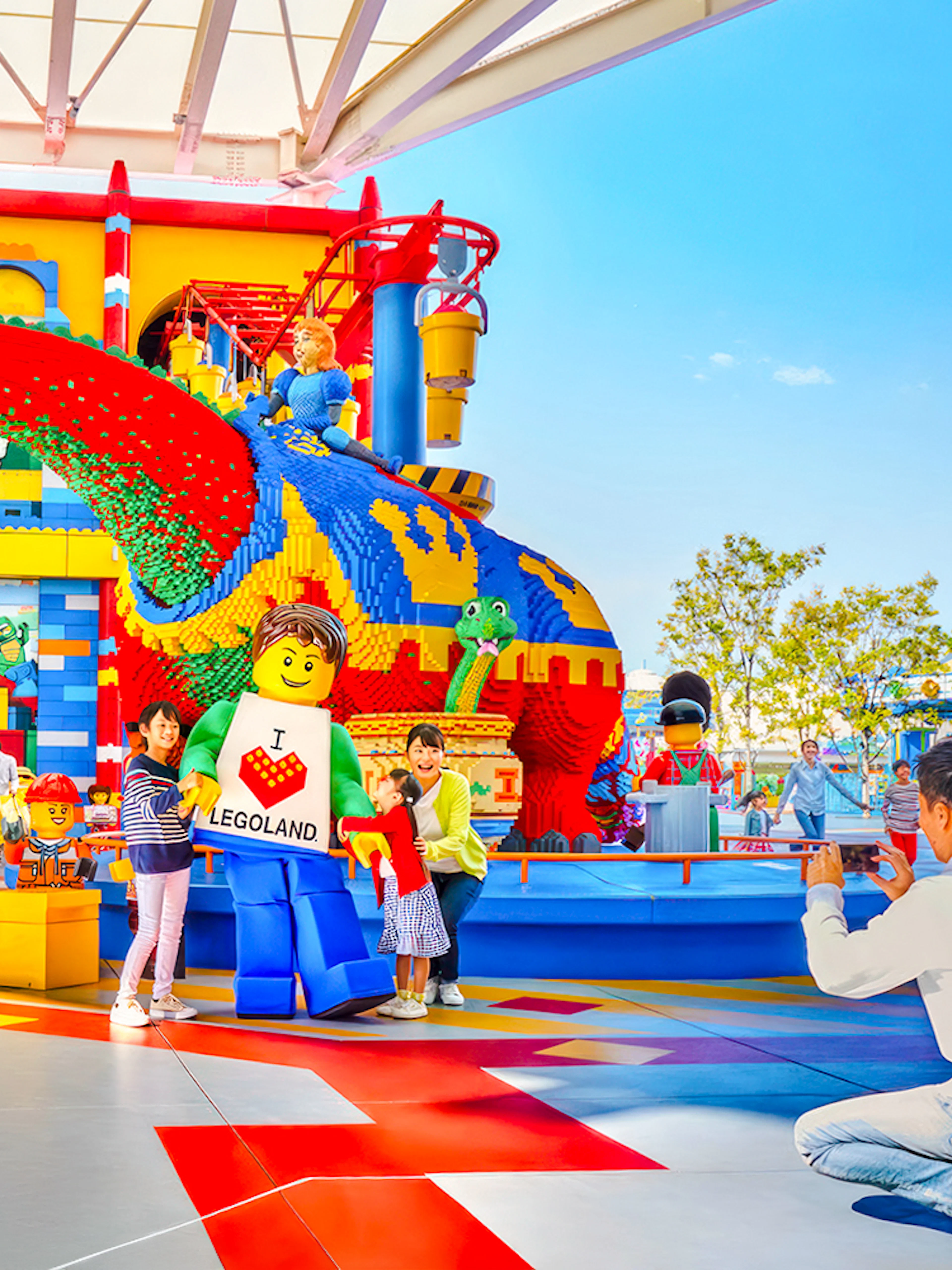 Visitors enjoying colorful Lego sculptures at Legoland Japan.