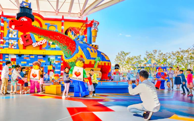 Visitors enjoying colorful Lego sculptures at Legoland Japan.