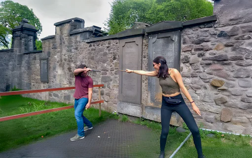 Two people reenacting a wand duel on the Harry Potter walking tour in Edinburgh.