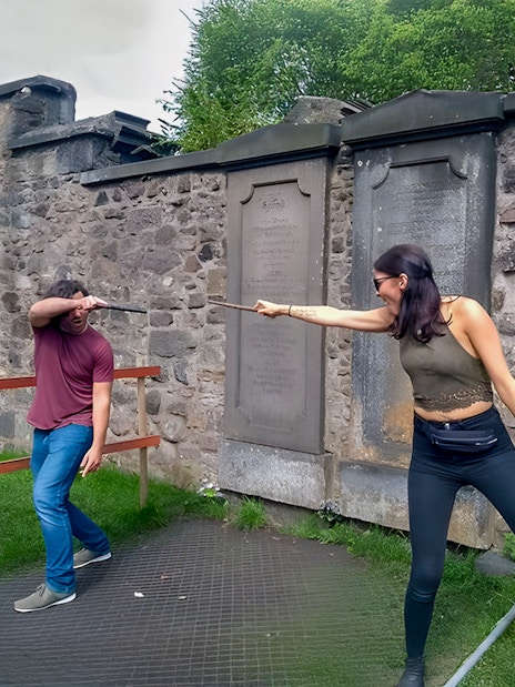Two people reenacting a wand duel on the Harry Potter walking tour in Edinburgh.