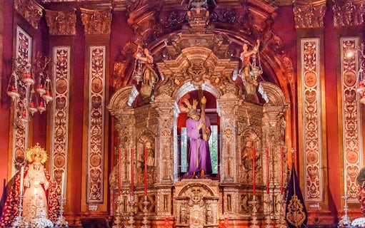 Ornate altar inside Salvador church, featuring religious statues and intricate carvings.
