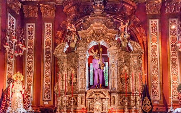 Ornate altar inside Salvador church, featuring religious statues and intricate carvings.
